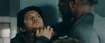 Movie still from “Triple Threat” (2019), directed by Jesse V. Johnson – A man with a beard is holding another man's hand; Close Up shot, Over the shoulder angle