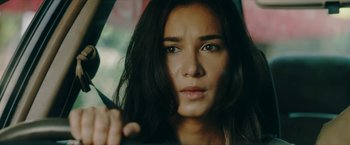 Movie still from “Triple Threat” (2019), directed by Jesse V. Johnson – A person holding an umbrella; Close Up shot, Low angle