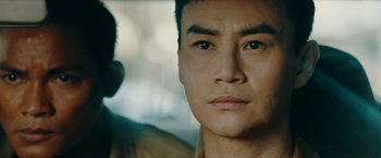 Movie still from “Triple Threat” (2019), directed by Jesse V. Johnson – A man's face in front of a window; Close Up shot, Over the shoulder angle