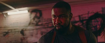 Movie still from “Triple Threat” (2019), directed by Jesse V. Johnson – A person with a beard; Close Up shot, Low angle