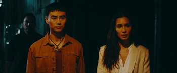 Movie still from “Triple Threat” (2019), directed by Jesse V. Johnson – A man and a woman standing next to each other; Close Up shot, Low angle