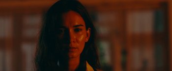 Movie still from “Triple Threat” (2019), directed by Jesse V. Johnson – A woman's face in the dark; Close Up shot, Low angle