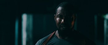 Movie still from “Triple Threat” (2019), directed by Jesse V. Johnson – A person with a beard; Close Up shot, Low angle