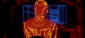 Movie still from “Tron” (1982), directed by Steven Lisberger – A man in a red suit is standing in front of a building; Medium shot, Low angle