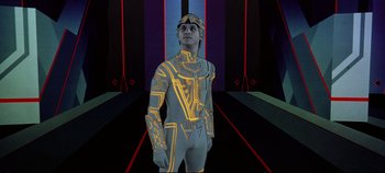 Movie still from “Tron” (1982), directed by Steven Lisberger – A man in a futuristic costume standing in a room; Medium shot, Low angle