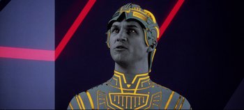 Movie still from “Tron” (1982), directed by Steven Lisberger – A man in a yellow and black suit with red lines in the background; Close Up shot, Low angle