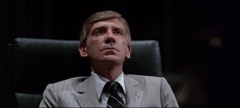 Movie still from “Tron” (1982), directed by Steven Lisberger – A person wearing a suit and tie; Close Up shot, Low angle