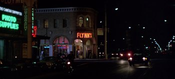 Movie still from “Tron” (1982), directed by Steven Lisberger – A building that is lit up at night; Wide shot, Low angle