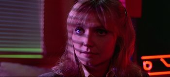 Movie still from “Tron” (1982), directed by Steven Lisberger – A person wearing a jacket; Close Up shot, Low angle