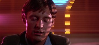 Movie still from “Tron” (1982), directed by Steven Lisberger – A person with his eyes closed; Close Up shot, Low angle