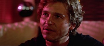 Movie still from “Tron” (1982), directed by Steven Lisberger – A man's face in a dark room; Close Up shot, Over the shoulder angle