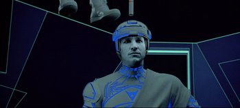 Movie still from “Tron” (1982), directed by Steven Lisberger – A man in a suit and a helmet is standing in front of a mirror; Close Up shot, Low angle