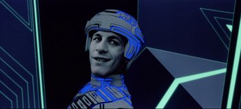 Movie still from “Tron” (1982), directed by Steven Lisberger – A man with a helmet is smiling for the camera; Close Up shot, Low angle