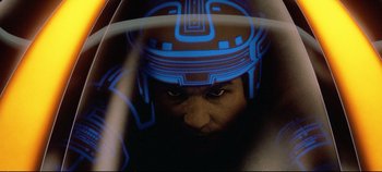 Movie still from “Tron” (1982), directed by Steven Lisberger – A man wearing a helmet with blue lights on it; Close Up shot, Low angle