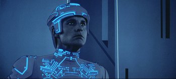 Movie still from “Tron” (1982), directed by Steven Lisberger – A man wearing a helmet with a circuit board design on it; Close Up shot, Low angle