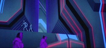 Movie still from “Tron” (1982), directed by Steven Lisberger – An image of a man in a purple jacket in a room; Extreme Wide shot, Low angle