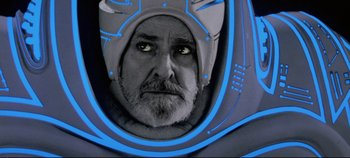 Movie still from “Tron” (1982), directed by Steven Lisberger – An older man with a helmet on his head; Close Up shot, Low angle