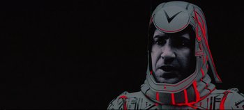 Movie still from “Tron” (1982), directed by Steven Lisberger – A person wearing a helmet; Close Up shot, Low angle