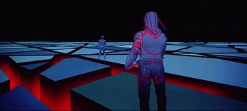 Movie still from “Tron” (1982), directed by Steven Lisberger – Two people standing in a room with red lines on the ground; Wide shot, Low angle