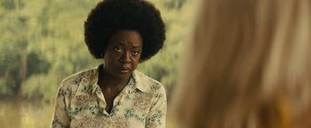 An older woman with an afro looking at the camera