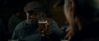 Movie still from “Trouble with the Curve” (2012), directed by Robert Lorenz – A man sitting at a table holding a glass of beer; Close Up shot, Over the shoulder angle