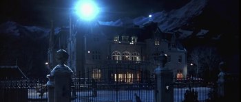 Movie still from “True Lies” (1994), directed by James Cameron – A building that is lit up at night time; Extreme Wide shot, Low angle