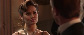 Movie still from “True Lies” (1994), directed by James Cameron – A woman in a black dress is looking at a man in a suit; Close Up shot, Over the shoulder angle