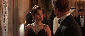 Movie still from “True Lies” (1994), directed by James Cameron – A woman in a black dress talking to a man in a tuxedo; Close Up shot, Over the shoulder angle