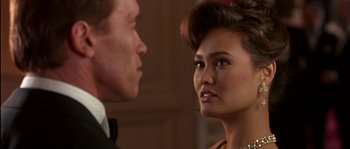 Movie still from “True Lies” (1994), directed by James Cameron – A man and a woman looking at one another; Close Up shot, Over the shoulder angle