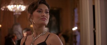 Movie still from “True Lies” (1994), directed by James Cameron – A woman in a black dress and a diamond necklace; Close Up shot, Low angle