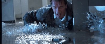 Movie still from “True Lies” (1994), directed by James Cameron – A man in black jacket and white shirt falling from a window; Medium shot, Low angle