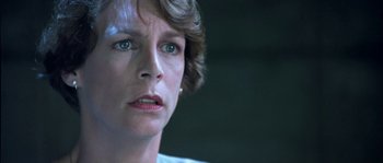 Movie still from “True Lies” (1994), directed by James Cameron – A person with short hair; Close Up shot, Low angle