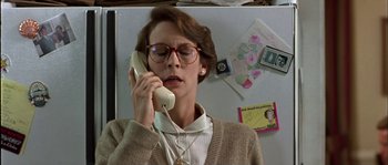 Movie still from “True Lies” (1994), directed by James Cameron – A woman talking on a phone in front of a refrigerator; Close Up shot, Low angle