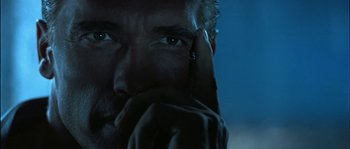 Movie still from “True Lies” (1994), directed by James Cameron – A person holding a cell phone up to their face; Extreme Close Up shot, Low angle
