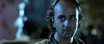 Movie still from “True Lies” (1994), directed by James Cameron – A person wearing a shirt; Close Up shot, Low angle