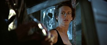 Movie still from “True Lies” (1994), directed by James Cameron – A person holding a cell phone; Close Up shot, Low angle