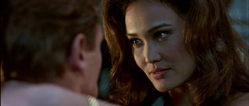 Movie still from “True Lies” (1994), directed by James Cameron – A woman's face as she looks at the camera; Close Up shot, Over the shoulder angle