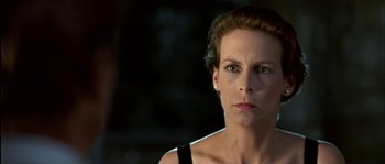 Movie still from “True Lies” (1994), directed by James Cameron – A person wearing a black shirt; Close Up shot, Low angle