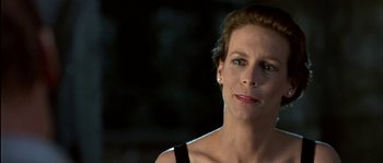 Movie still from “True Lies” (1994), directed by James Cameron – A person wearing a black shirt; Close Up shot, Low angle