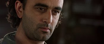 Movie still from “True Lies” (1994), directed by James Cameron – A man's face with a serious look on his face; Close Up shot, Low angle