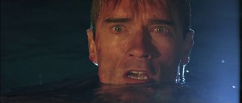 Movie still from “True Lies” (1994), directed by James Cameron – A person in a body of water; Close Up shot, Low angle