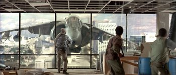 Movie still from “True Lies” (1994), directed by James Cameron – Two people looking out a window at an airplane; Wide shot, Low angle