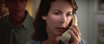 Movie still from “True Lies” (1994), directed by James Cameron – A person talking on a phone; Close Up shot, Low angle