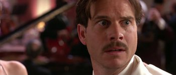 Movie still from “True Lies” (1994), directed by James Cameron – A person with a mustache; Close Up shot, Low angle