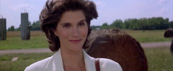 Movie still from “Twister” (1996), directed by Jan de Bont – A person with a horse in the background; Close Up shot, Low angle