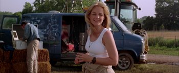 Movie still from “Twister” (1996), directed by Jan de Bont – A woman standing in front of an old van; Medium shot, Low angle