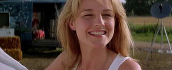 Movie still from “Twister” (1996), directed by Jan de Bont – A woman smiling for the camera; Close Up shot, Low angle