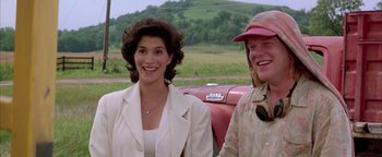 Movie still from “Twister” (1996), directed by Jan de Bont – A woman standing next to a man next to an old car; Close Up shot, Over the shoulder angle