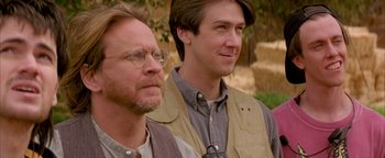 Movie still from “Twister” (1996), directed by Jan de Bont – Two men standing next to each other in a field; Close Up shot, Over the shoulder angle