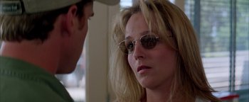 Movie still from “Twister” (1996), directed by Jan de Bont – A person wearing sunglasses; Close Up shot, Over the shoulder angle